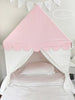 Pink and white children's bed canopy with scalloped edge in a bedroom setting.