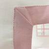 Close-up of a pink fabric corner with a blurred background