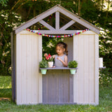 Jack & June wooden outdoor playhouse for kids with windows, door, and porch – ideal backyard play structure for imaginative play.